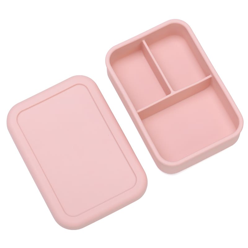 Lonchera de silicona rosada abierta con tres divisiones internas. Caja bento moderna para organizar la colación de niños