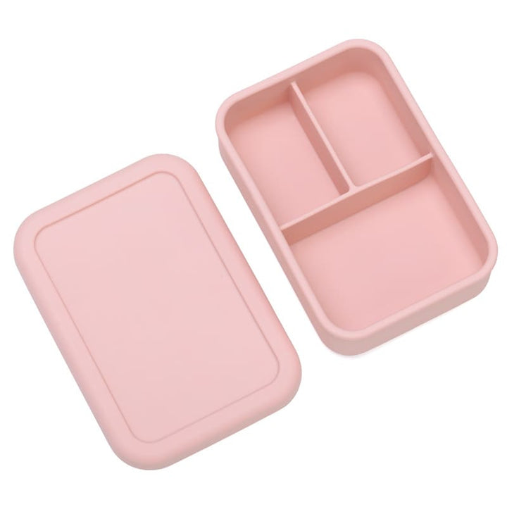 Lonchera de silicona rosada abierta con tres divisiones internas. Caja bento moderna para organizar la colación de niños