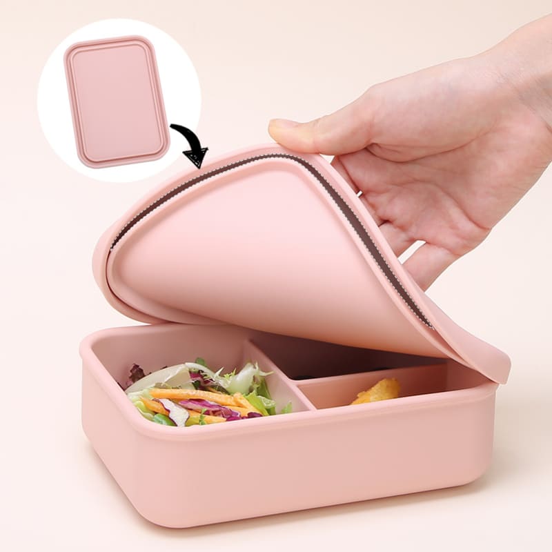Caja bento de silicona rosada para comida, con tapa flexible y divisiones internas. Envase para llevar almuerzo