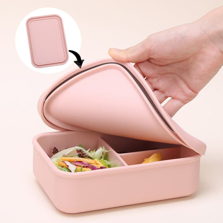 Caja bento de silicona rosada para comida, con tapa flexible y divisiones internas. Envase para llevar almuerzo