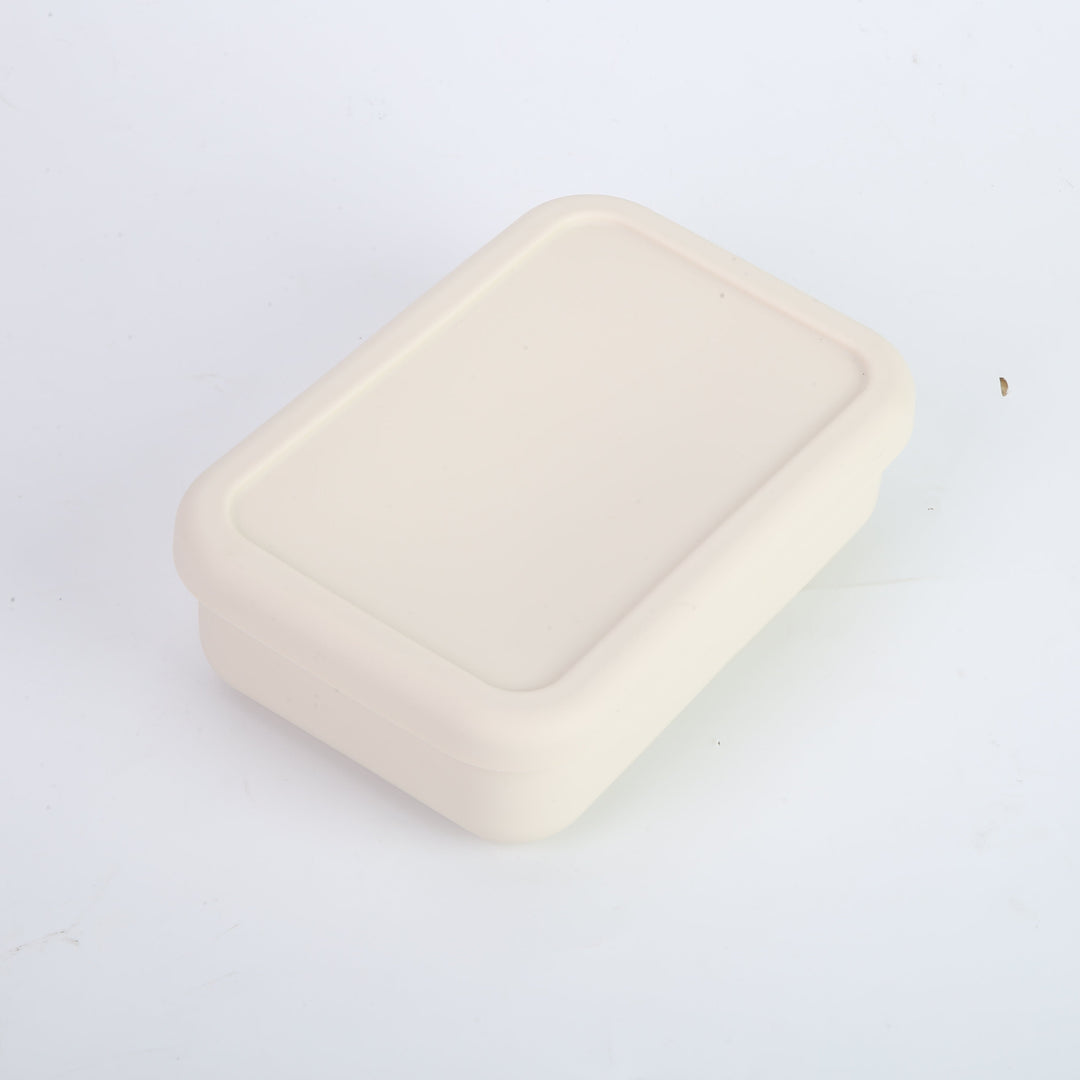 Tupper de silicona crema con tapa hermética para almuerzo. Contenedor de comida compacto y seguro, ideal para transportar colaciones