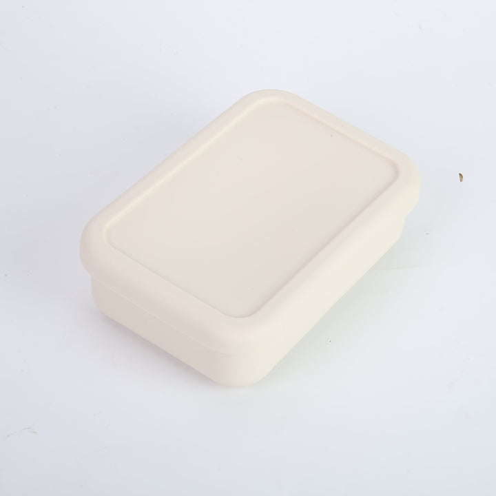 Tupper de silicona crema con tapa hermética para almuerzo. Contenedor de comida compacto y seguro, ideal para transportar colaciones