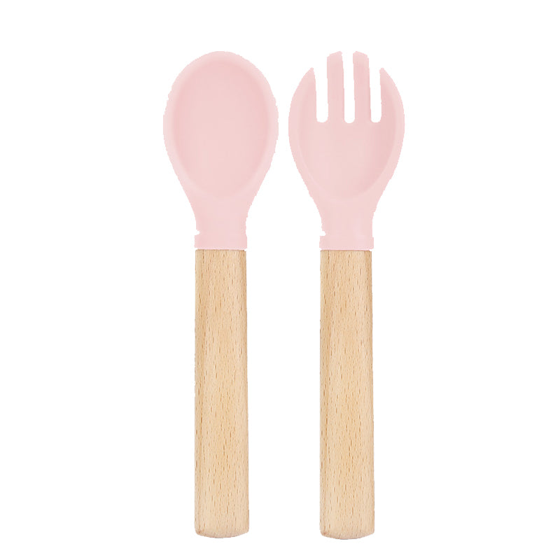 Set de cuchara y tenedor de silicona rosado con mango de madera para bebé