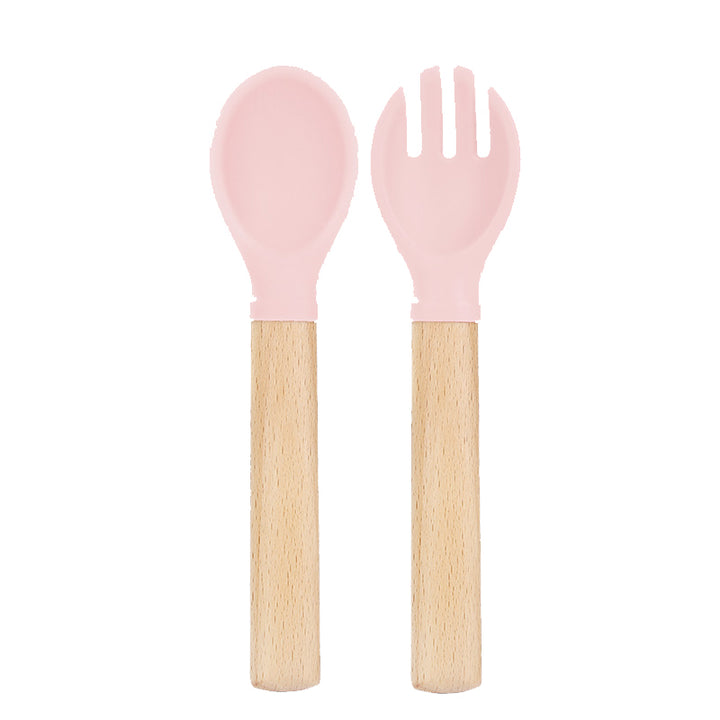 Set de cuchara y tenedor de silicona rosado con mango de madera para bebé